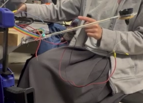 The dangling wires added extra weight that skewed our graphs and added more tension than necessary. Those were then taped to the wooden stick